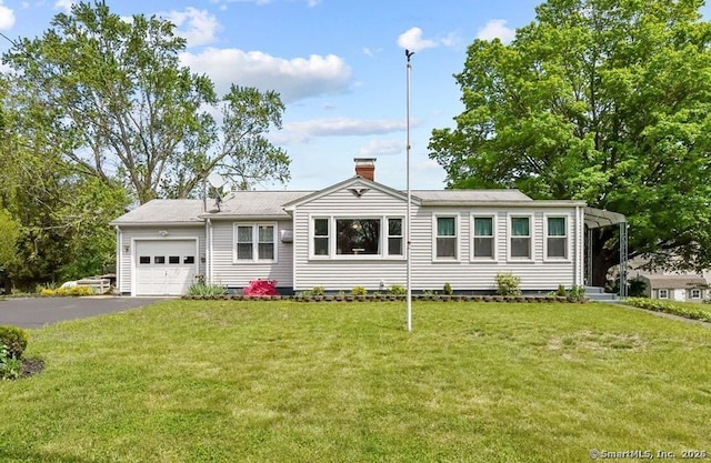 53 Cleveland St, Putnam, CT 06260 - view of front of house with an attached garage, asphalt driveway, a front lawn, and a chimney