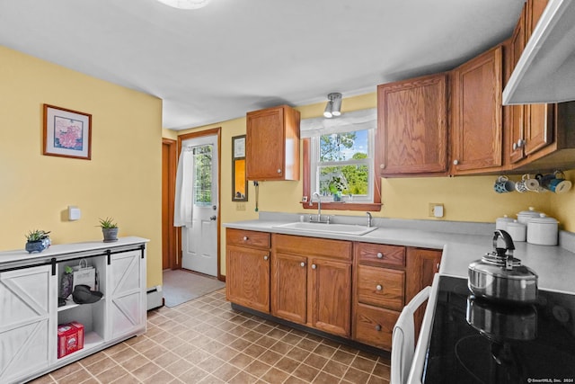 53 Cleveland St, Putnam, CT 06260 - kitchen featuring exhaust hood, light countertops, brown cabinets, and range with electric cooktop