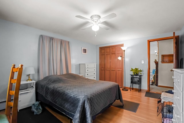 53 Cleveland St, Putnam, CT 06260 - bedroom with light wood-style flooring, a closet, a baseboard radiator, and ceiling fan
