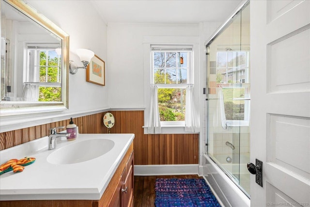 43 N Main St, Chester, CT 06412 - bathroom with vanity, wainscoting, bath / shower combo with glass door, wood finished floors, and crown molding