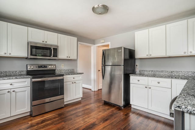 30 Jackson Ave, West Hartford, CT 06110 - kitchen with appliances with stainless steel finishes, dark wood-type flooring, white cabinetry, and light stone countertops
