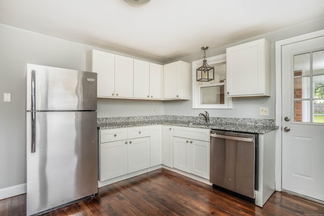 30 Jackson Ave, West Hartford, CT 06110 - kitchen featuring appliances with stainless steel finishes, light stone counters, dark wood-type flooring, white cabinetry, and hanging light fixtures