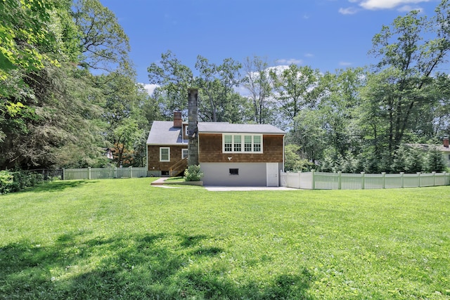 39 Clover Dr, Wilton, CT 06897 - rear view of house with a fenced backyard, a chimney, a patio area, and view of wooded area