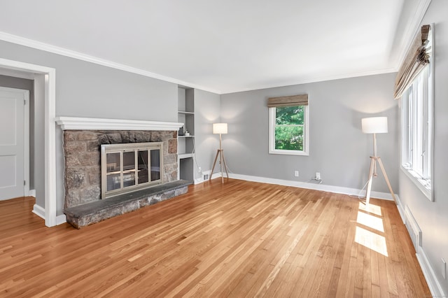 39 Clover Dr, Wilton, CT 06897 - unfurnished living room featuring hardwood / wood-style flooring, crown molding, built in features, and a stone fireplace