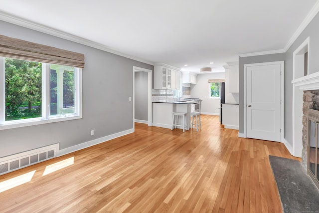 39 Clover Dr, Wilton, CT 06897 - unfurnished living room with a fireplace, ornamental molding, and light wood finished floors