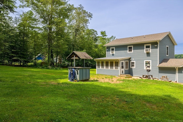 70 Laurel Hill Dr, Woodstock, CT 06282 - back of property with a sunroom, a lawn, and entry steps