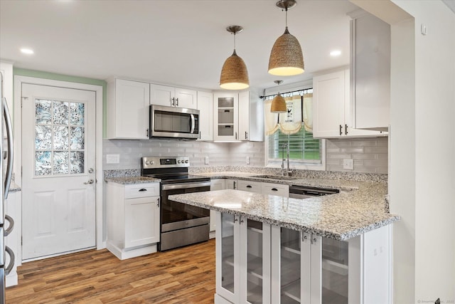 70 Laurel Hill Dr, Woodstock, CT 06282 - kitchen with stainless steel appliances, white cabinetry, light wood-style floors, a peninsula, and recessed lighting