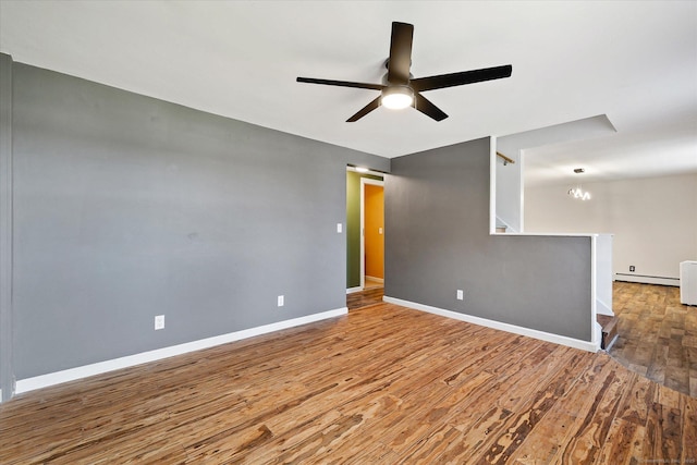 70 Laurel Hill Dr, Woodstock, CT 06282 - spare room with wood finished floors, a ceiling fan, baseboard heating, stairs, and a chandelier