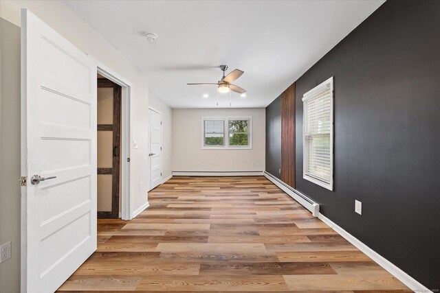 70 Laurel Hill Dr, Woodstock, CT 06282 - unfurnished room featuring a baseboard heating unit, ceiling fan, light wood-type flooring, and a smoke detector