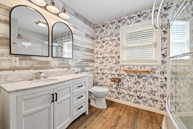 70 Laurel Hill Dr, Woodstock, CT 06282 - full bathroom with wallpapered walls, wood finished floors, vanity, plenty of natural light, and washtub / shower combination