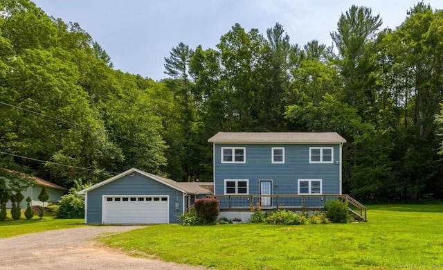70 Laurel Hill Dr, Woodstock, CT 06282 - colonial house with a garage, a front lawn, and a wooden deck