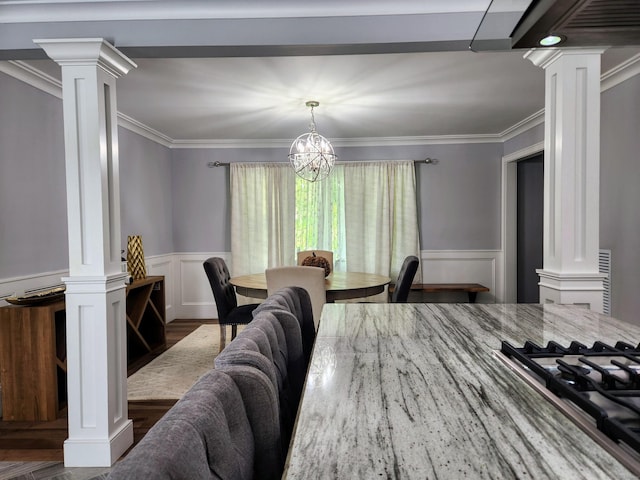 3 Old Woods Rd, Brookfield, CT 06804 - dining room featuring decorative columns, wood finished floors, a chandelier, crown molding, and a decorative wall