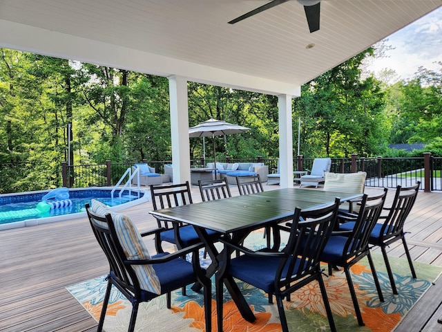 3 Old Woods Rd, Brookfield, CT 06804 - wooden terrace with outdoor dining space, an outdoor hangout area, an outdoor pool, a ceiling fan, and view of wooded area