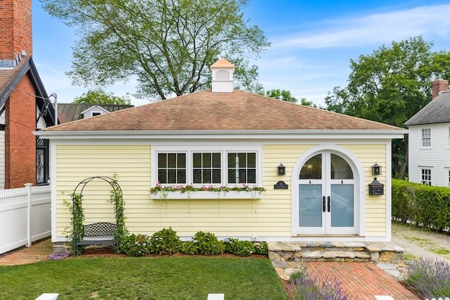 5 S Main St, Essex, CT 06426 - rear view of property featuring a shingled roof and french doors