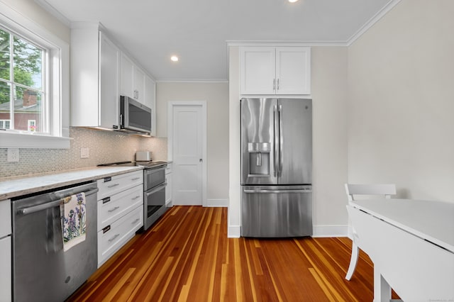 5 S Main St, Essex, CT 06426 - kitchen with stainless steel appliances, ornamental molding, tasteful backsplash, white cabinetry, and dark wood-style flooring