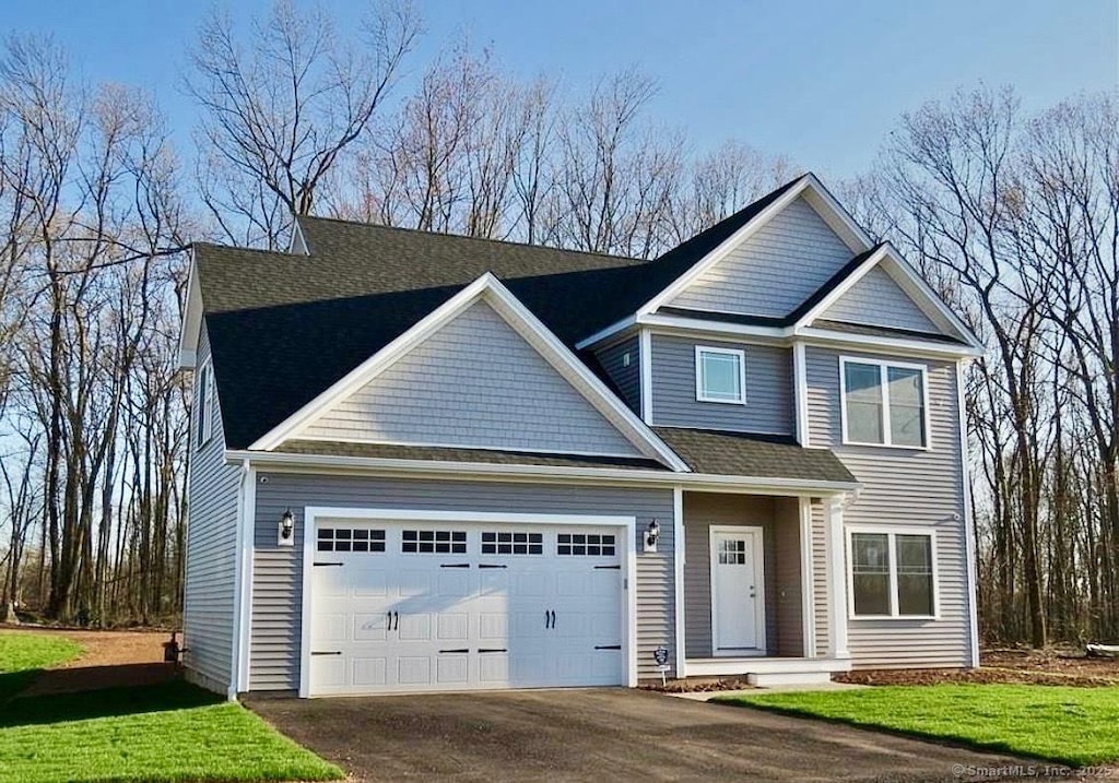 1323 Barnes Rd, Wallingford, CT 06492 - view of front facade with a garage, driveway, and a front lawn