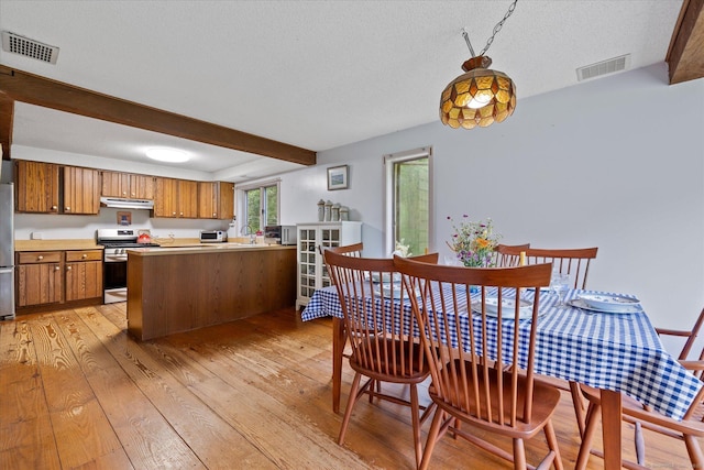 853 Pole Bridge Rd, Woodstock, CT 06281 - dining area featuring light wood-style flooring, beam ceiling, and a textured ceiling