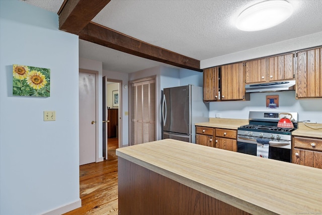 853 Pole Bridge Rd, Woodstock, CT 06281 - kitchen with stainless steel appliances, under cabinet range hood, a textured ceiling, light countertops, and brown cabinetry
