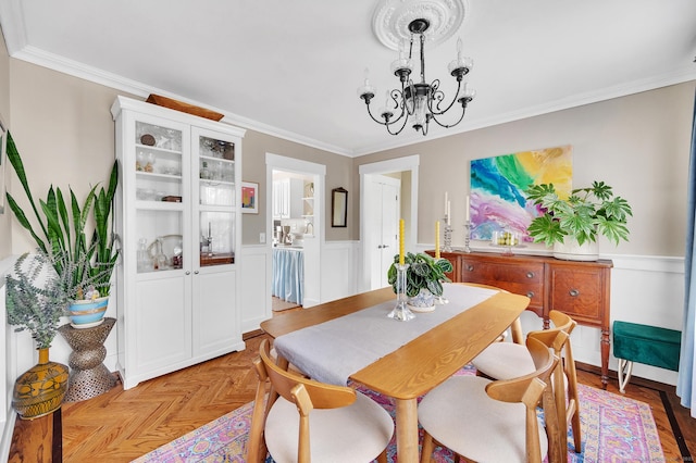 12 Scott St, West Haven, CT 06516 - dining space with ornamental molding, a chandelier, and a wainscoted wall