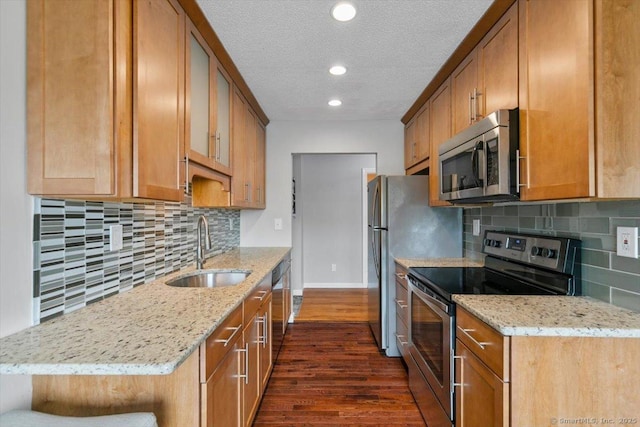 153 Marconi Ave Unit 153, Bridgeport, CT 06606 - kitchen featuring appliances with stainless steel finishes, dark wood-style flooring, light stone counters, backsplash, and glass insert cabinets