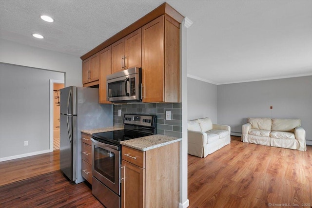 153 Marconi Ave Unit 153, Bridgeport, CT 06606 - kitchen featuring stainless steel appliances, dark wood-style flooring, open floor plan, brown cabinetry, and ornamental molding