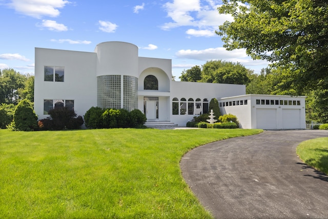 45 Brookview Ct, Groton, CT 06340 - view of front of home with stucco siding, a front yard, asphalt driveway, and an attached garage