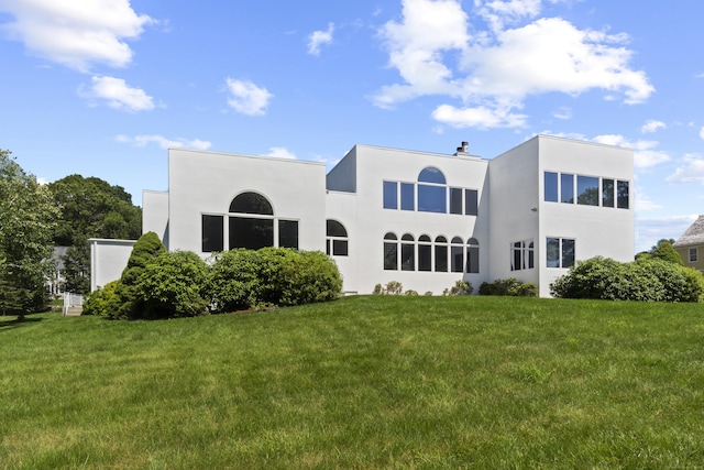 45 Brookview Ct, Groton, CT 06340 - back of property featuring a yard and stucco siding