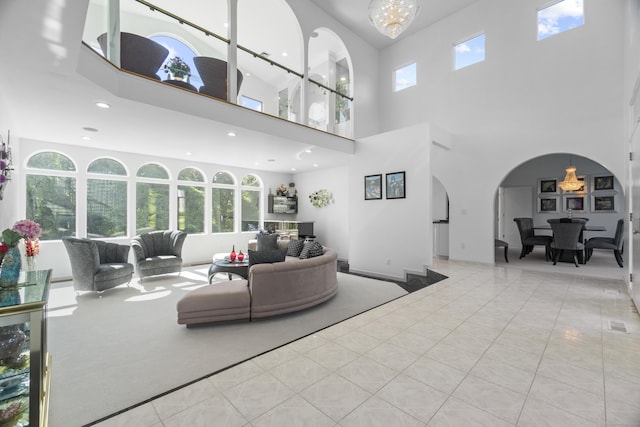 45 Brookview Ct, Groton, CT 06340 - living area with a high ceiling, healthy amount of natural light, arched walkways, a chandelier, and recessed lighting