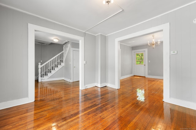 49 Freeman Ave, Norwich, CT 06360 - spare room with ornamental molding, stairs, hardwood / wood-style floors, and a chandelier