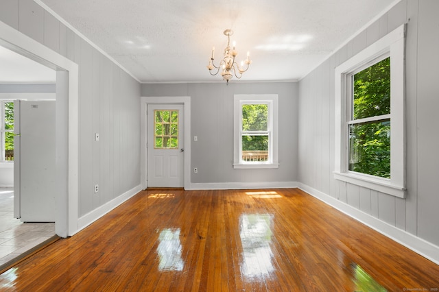 49 Freeman Ave, Norwich, CT 06360 - unfurnished dining area with crown molding, hardwood / wood-style floors, and a chandelier