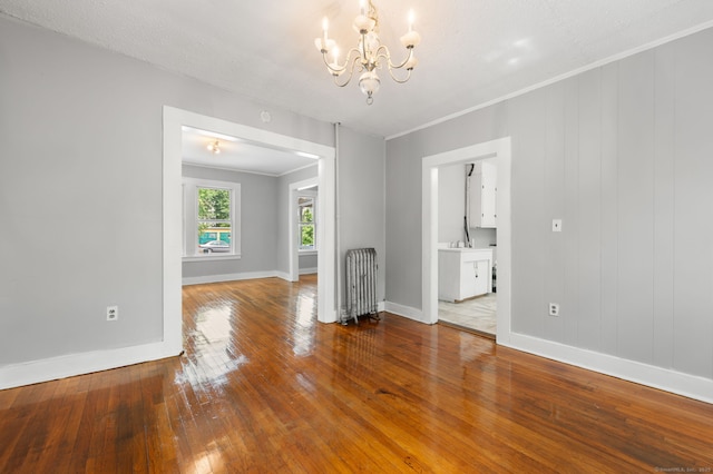 49 Freeman Ave, Norwich, CT 06360 - spare room featuring radiator, a chandelier, hardwood / wood-style flooring, and crown molding