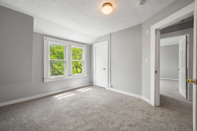 49 Freeman Ave, Norwich, CT 06360 - unfurnished bedroom featuring a textured ceiling, lofted ceiling, carpet flooring, and a closet