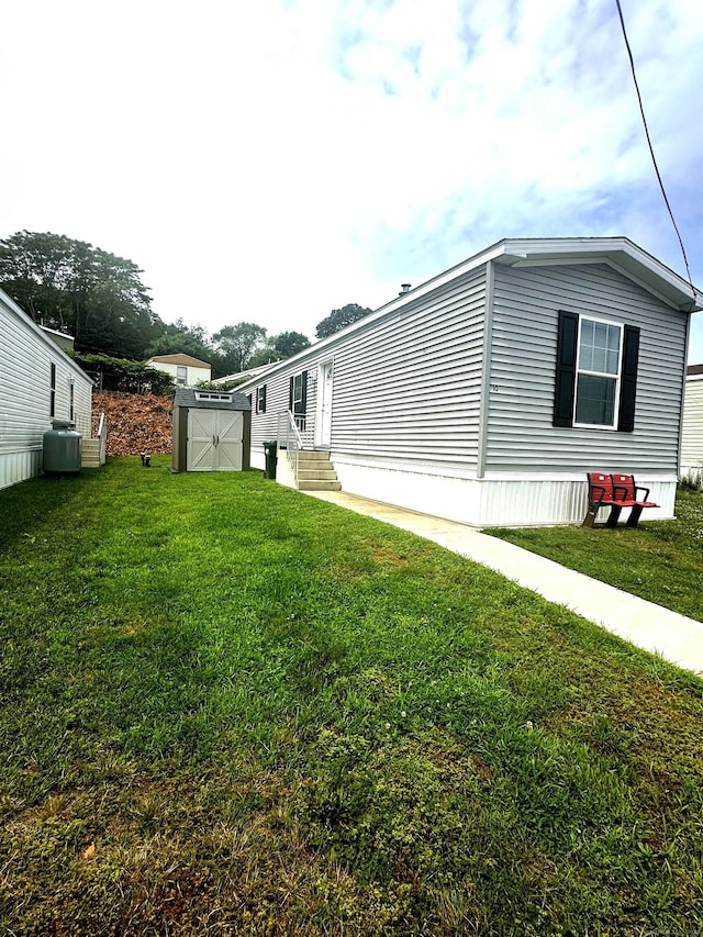 435 High St Lot 10, Groton, CT 06355 - view of property exterior with a shed, a lawn, and entry steps