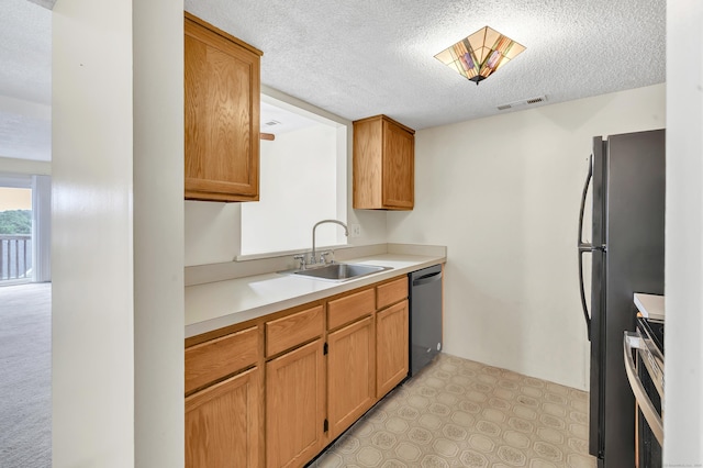 173 Russo Ave Unit 409, East Haven, CT 06513 - kitchen with appliances with stainless steel finishes, a textured ceiling, light countertops, and brown cabinetry