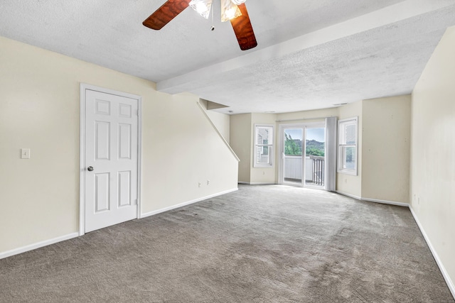 173 Russo Ave Unit 409, East Haven, CT 06513 - spare room featuring a ceiling fan, carpet, a textured ceiling, and stairs