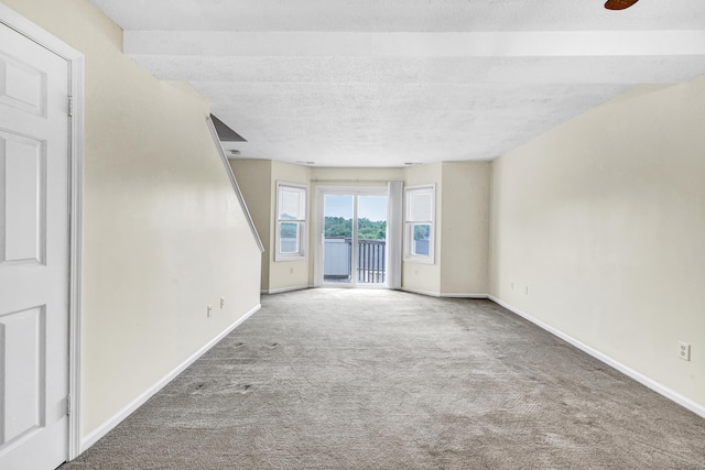 173 Russo Ave Unit 409, East Haven, CT 06513 - unfurnished living room featuring carpet floors and a textured ceiling