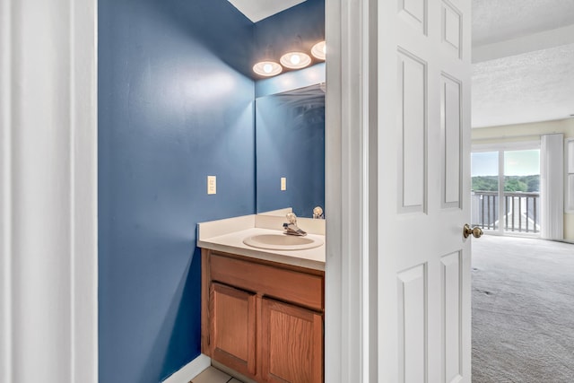 173 Russo Ave Unit 409, East Haven, CT 06513 - bathroom with a textured ceiling and vanity
