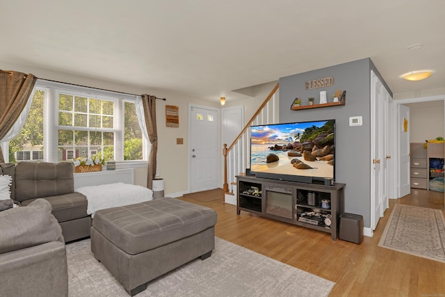 40 Rosina Rd, Hamden, CT 06514 - living area featuring stairway, wood finished floors, and radiator heating unit