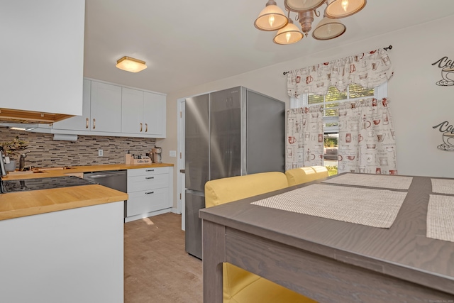 40 Rosina Rd, Hamden, CT 06514 - kitchen with butcher block counters, stainless steel appliances, a chandelier, backsplash, and white cabinets