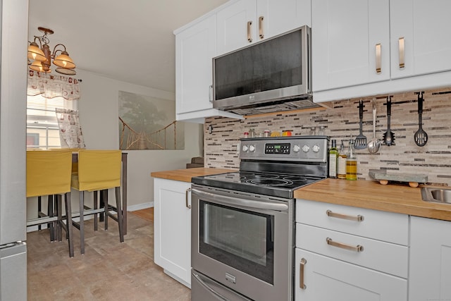 40 Rosina Rd, Hamden, CT 06514 - kitchen with appliances with stainless steel finishes, butcher block counters, decorative backsplash, and white cabinets
