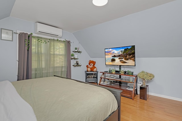40 Rosina Rd, Hamden, CT 06514 - bedroom featuring a wall unit AC, vaulted ceiling, and light wood finished floors