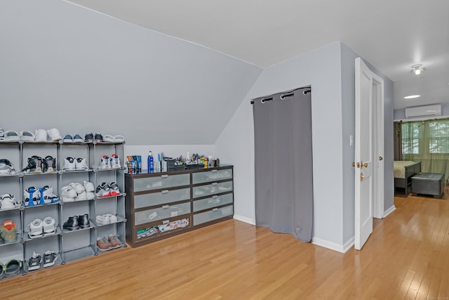 40 Rosina Rd, Hamden, CT 06514 - additional living space with wood finished floors, an AC wall unit, and vaulted ceiling