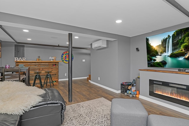 40 Rosina Rd, Hamden, CT 06514 - living room with wood finished floors, a wall mounted AC, recessed lighting, and a glass covered fireplace