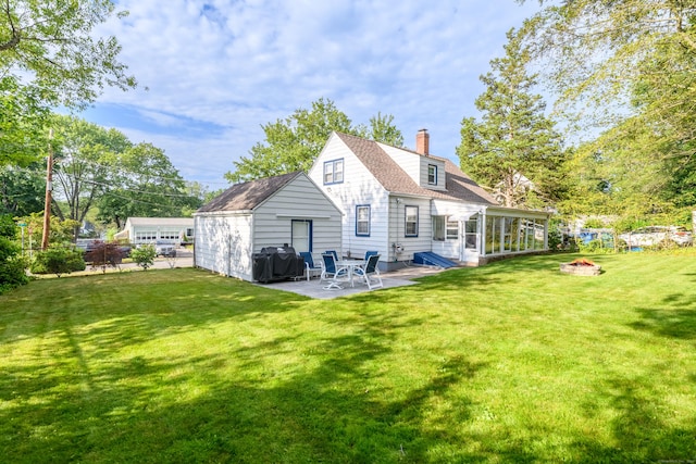 40 Rosina Rd, Hamden, CT 06514 - back of property with a patio, a chimney, a fire pit, and a sunroom
