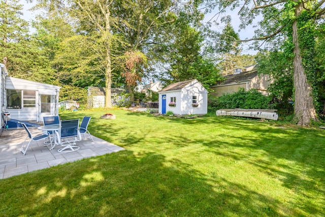 40 Rosina Rd, Hamden, CT 06514 - view of green lawn with a shed, a patio area, and a fire pit