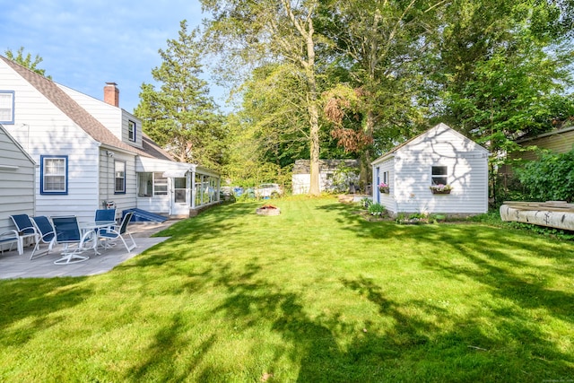 40 Rosina Rd, Hamden, CT 06514 - view of yard featuring a patio area, an outdoor fire pit, and an outbuilding