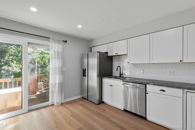 121 Russo Ave Unit 11, East Haven, CT 06513 - kitchen with appliances with stainless steel finishes, backsplash, white cabinetry, light wood finished floors, and recessed lighting