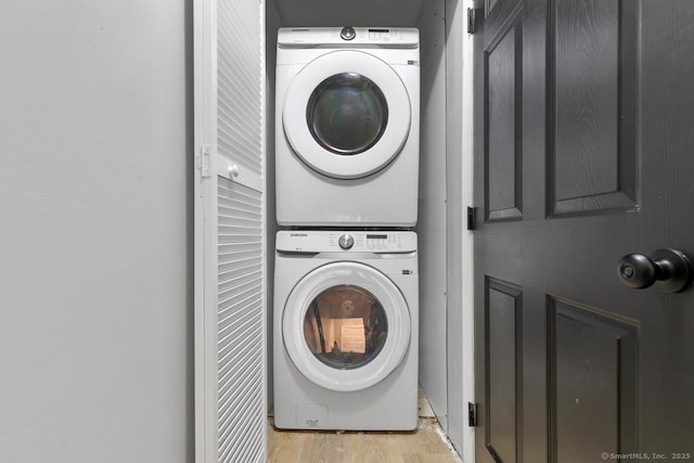 121 Russo Ave Unit 11, East Haven, CT 06513 - laundry room with stacked washer / drying machine and light wood-style floors