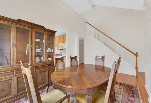 6 Mountainview Cir Unit 6, Ellington, CT 06029 - dining room featuring stairway, light wood-style flooring, and lofted ceiling