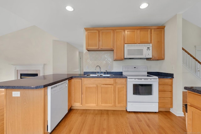 6 Mountainview Cir Unit 6, Ellington, CT 06029 - kitchen featuring white appliances, light wood finished floors, dark countertops, a peninsula, and backsplash